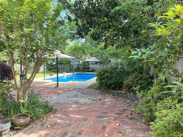 view of swimming pool featuring a patio, a gazebo, a fenced in pool, and a fenced backyard
