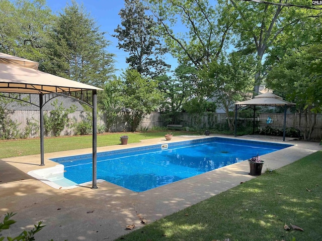 view of pool featuring a patio area, a gazebo, a fenced in pool, a fenced backyard, and a yard