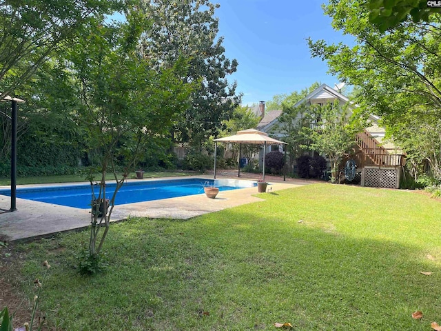 pool with a fenced backyard, a patio, a gazebo, and a yard