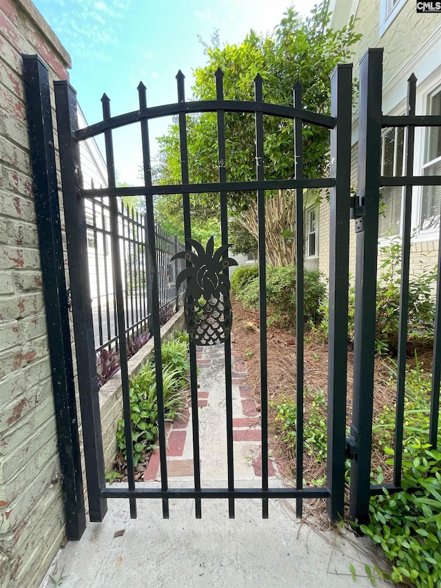 view of gate with fence