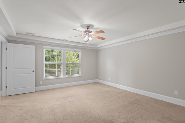 spare room with visible vents, crown molding, baseboards, and ceiling fan