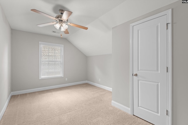 additional living space with carpet flooring, ceiling fan, baseboards, lofted ceiling, and visible vents