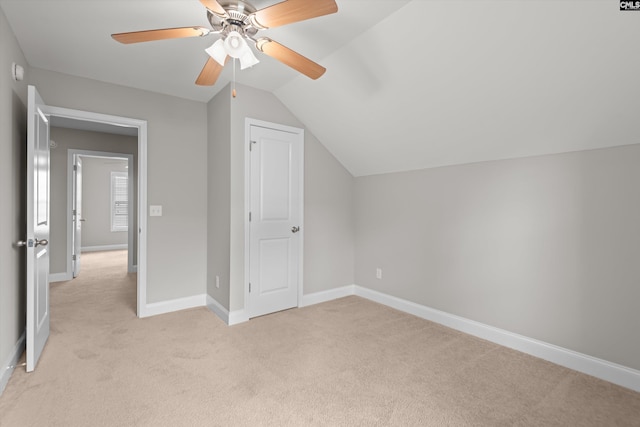 bonus room featuring baseboards, a ceiling fan, lofted ceiling, and light carpet