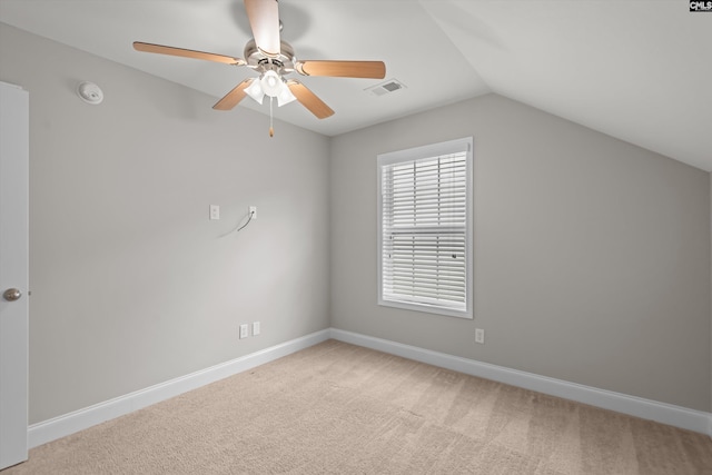 additional living space with visible vents, light carpet, baseboards, a ceiling fan, and vaulted ceiling