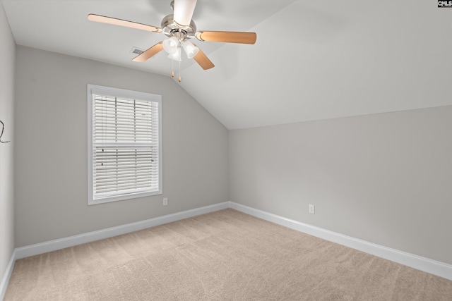 additional living space with baseboards, a ceiling fan, vaulted ceiling, and carpet flooring