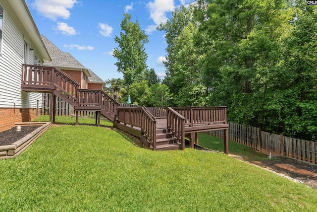 view of yard with stairs, fence, and a deck