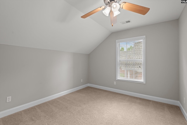 additional living space featuring visible vents, carpet flooring, baseboards, and vaulted ceiling