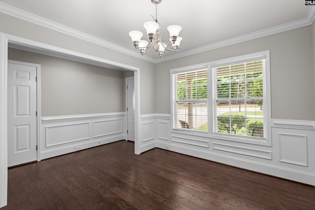 empty room with an inviting chandelier, a wainscoted wall, ornamental molding, and dark wood finished floors