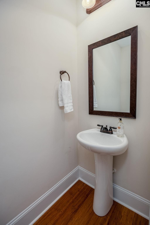 bathroom featuring baseboards and wood finished floors