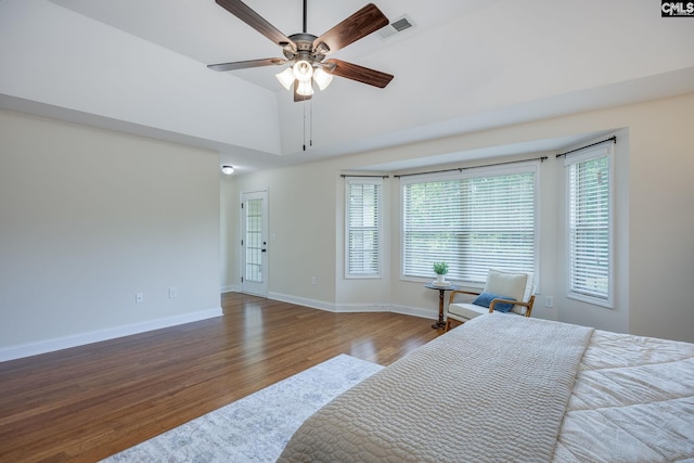 bedroom with baseboards, a ceiling fan, wood finished floors, and visible vents