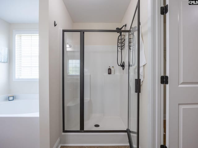 bathroom with a garden tub and a shower stall