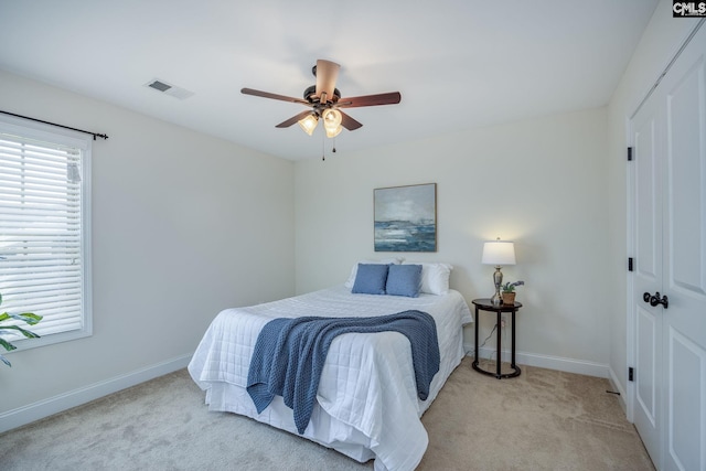 carpeted bedroom with baseboards, a closet, and visible vents