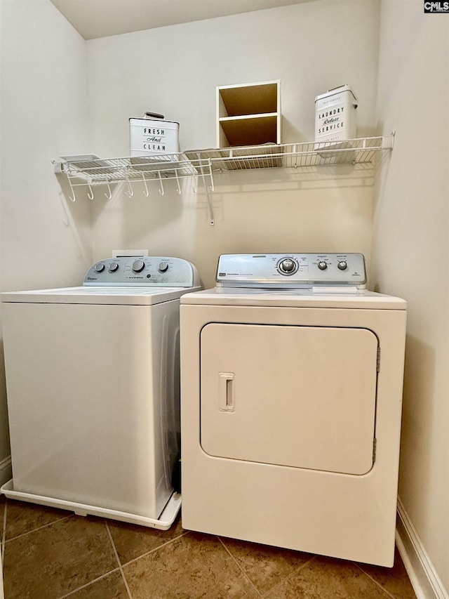 laundry room featuring laundry area, tile patterned flooring, and washing machine and dryer