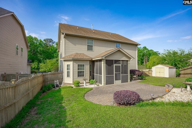 back of property featuring an outdoor structure, a storage shed, a sunroom, a patio, and a yard