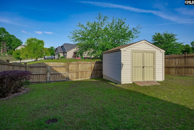 view of yard with a storage shed, an outdoor structure, a gate, and a fenced backyard