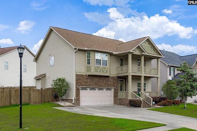 craftsman-style house featuring driveway, a front yard, fence, a balcony, and an attached garage