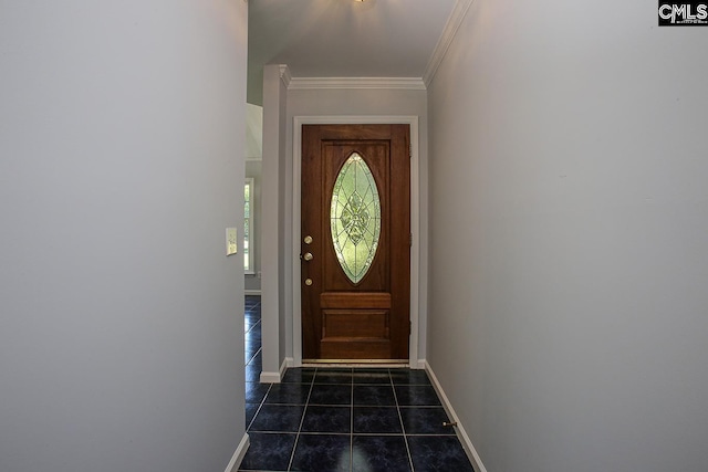 doorway with crown molding, baseboards, and dark tile patterned flooring