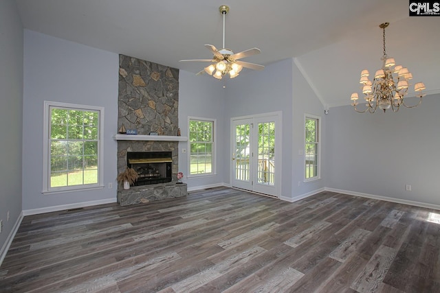 unfurnished living room with a stone fireplace, wood finished floors, baseboards, high vaulted ceiling, and ceiling fan with notable chandelier