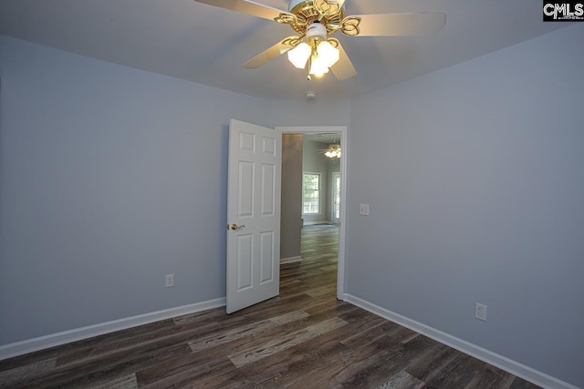 empty room with baseboards, a ceiling fan, and wood finished floors