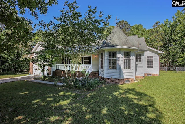 view of front of home featuring fence, a shingled roof, a front yard, crawl space, and covered porch