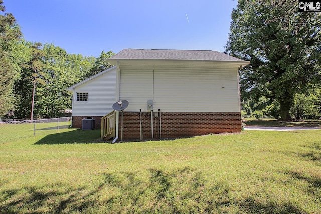 view of home's exterior with fence, a yard, and cooling unit