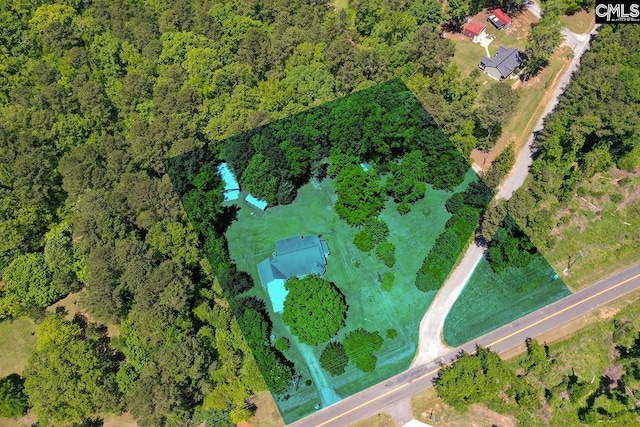 drone / aerial view with a wooded view