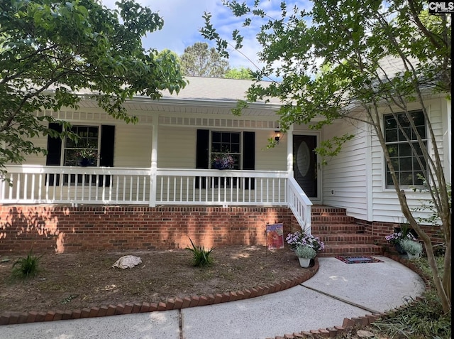 single story home featuring covered porch