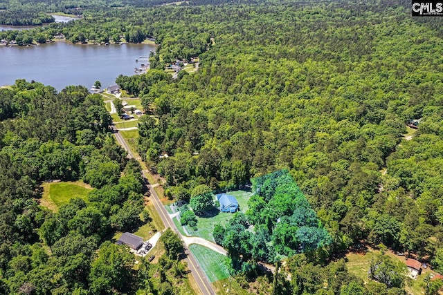 drone / aerial view featuring a water view and a forest view