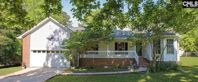 view of front facade with concrete driveway, a porch, brick siding, and a front yard