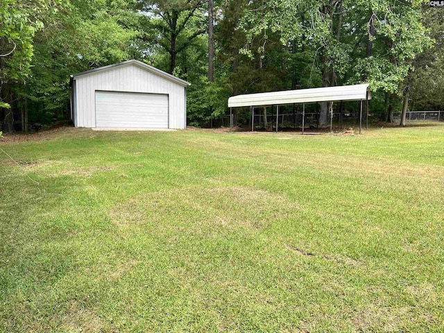 view of yard featuring a garage and an outbuilding