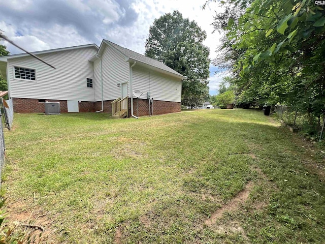 exterior space featuring central AC and fence