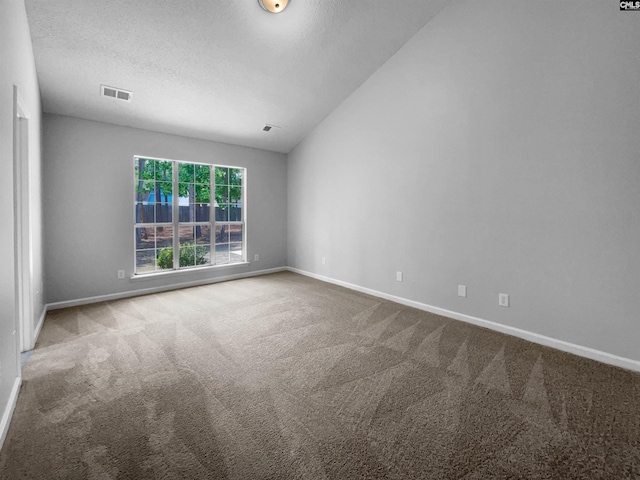 spare room with carpet floors, baseboards, and visible vents