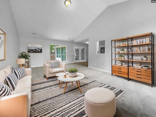 carpeted living area featuring baseboards, high vaulted ceiling, visible vents, and french doors