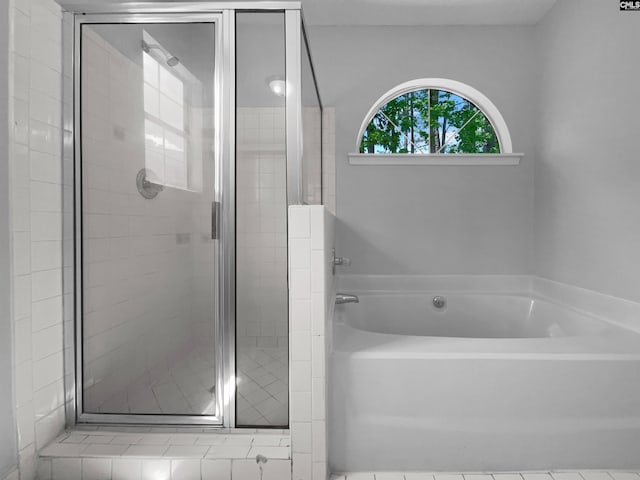 bathroom with a garden tub and a stall shower