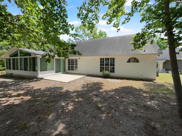 rear view of house with a sunroom and a patio area
