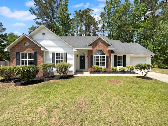 single story home with brick siding, an attached garage, and a front yard