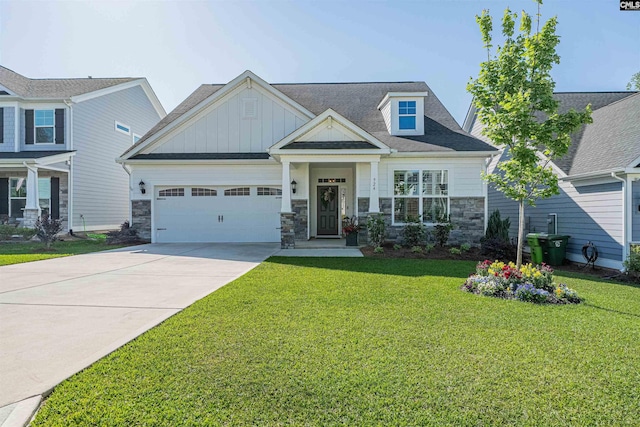 craftsman-style home featuring a garage, a front lawn, stone siding, board and batten siding, and concrete driveway
