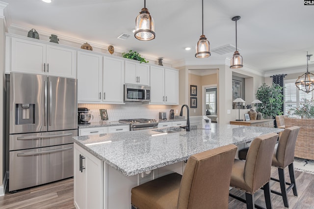 kitchen with a sink, appliances with stainless steel finishes, and white cabinets