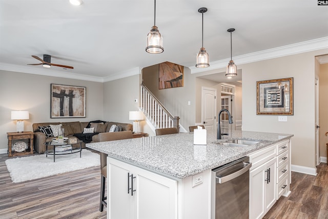 kitchen featuring stainless steel dishwasher, a sink, dark wood-style flooring, and crown molding