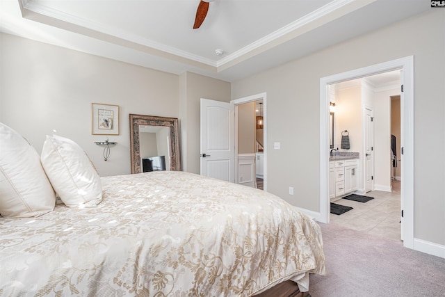 bedroom with crown molding, baseboards, light carpet, and ensuite bathroom