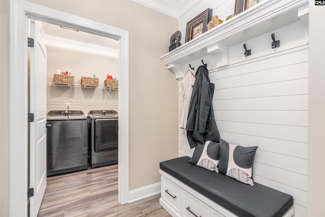 mudroom featuring light wood-style floors, ornamental molding, baseboards, and independent washer and dryer