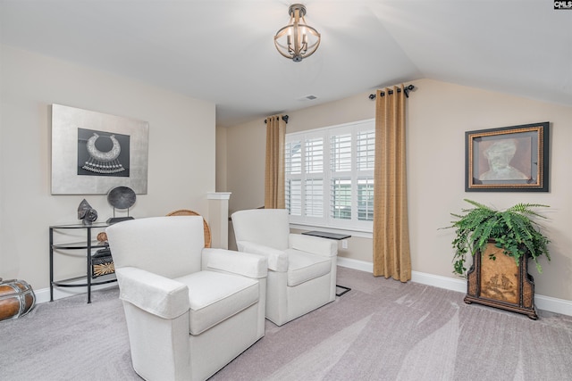 living area featuring baseboards, visible vents, vaulted ceiling, and light colored carpet