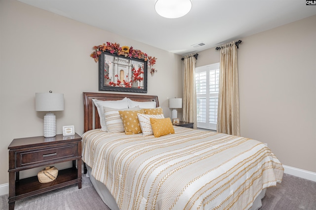 carpeted bedroom featuring baseboards and visible vents