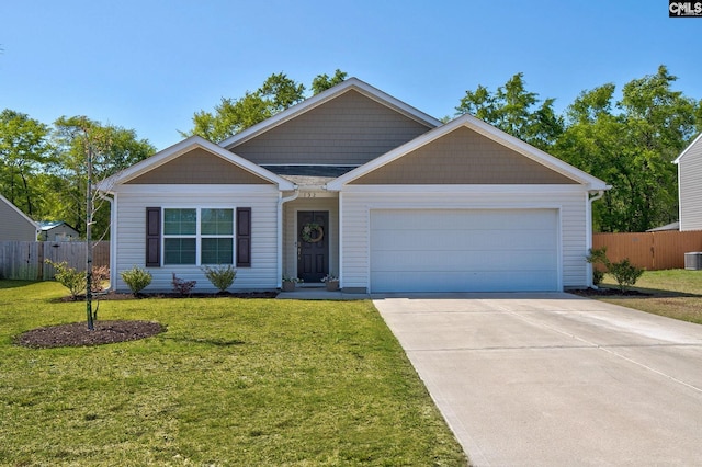 view of front facade with fence, a front lawn, driveway, and a garage