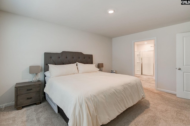 bedroom featuring baseboards, light carpet, recessed lighting, and connected bathroom