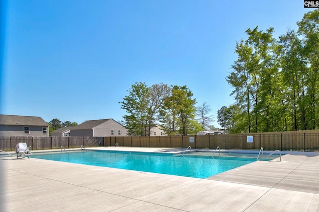 community pool featuring a patio and fence