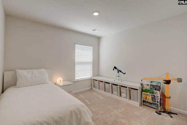 carpeted bedroom featuring baseboards and visible vents
