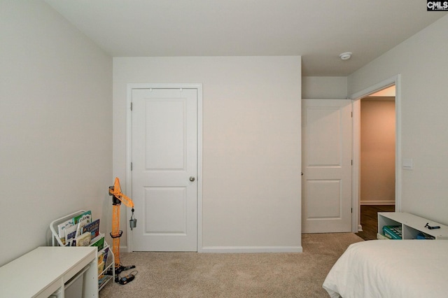bedroom with carpet floors and baseboards