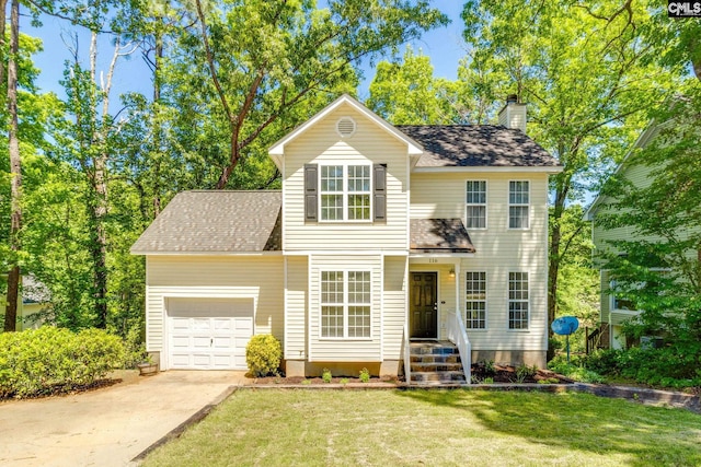 traditional home featuring a garage, a shingled roof, a front yard, and concrete driveway