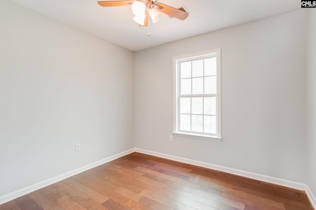 unfurnished room featuring light wood-type flooring, baseboards, and ceiling fan